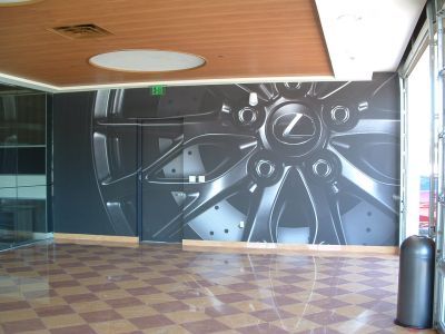 An empty room with a picture of a wheel on the wall