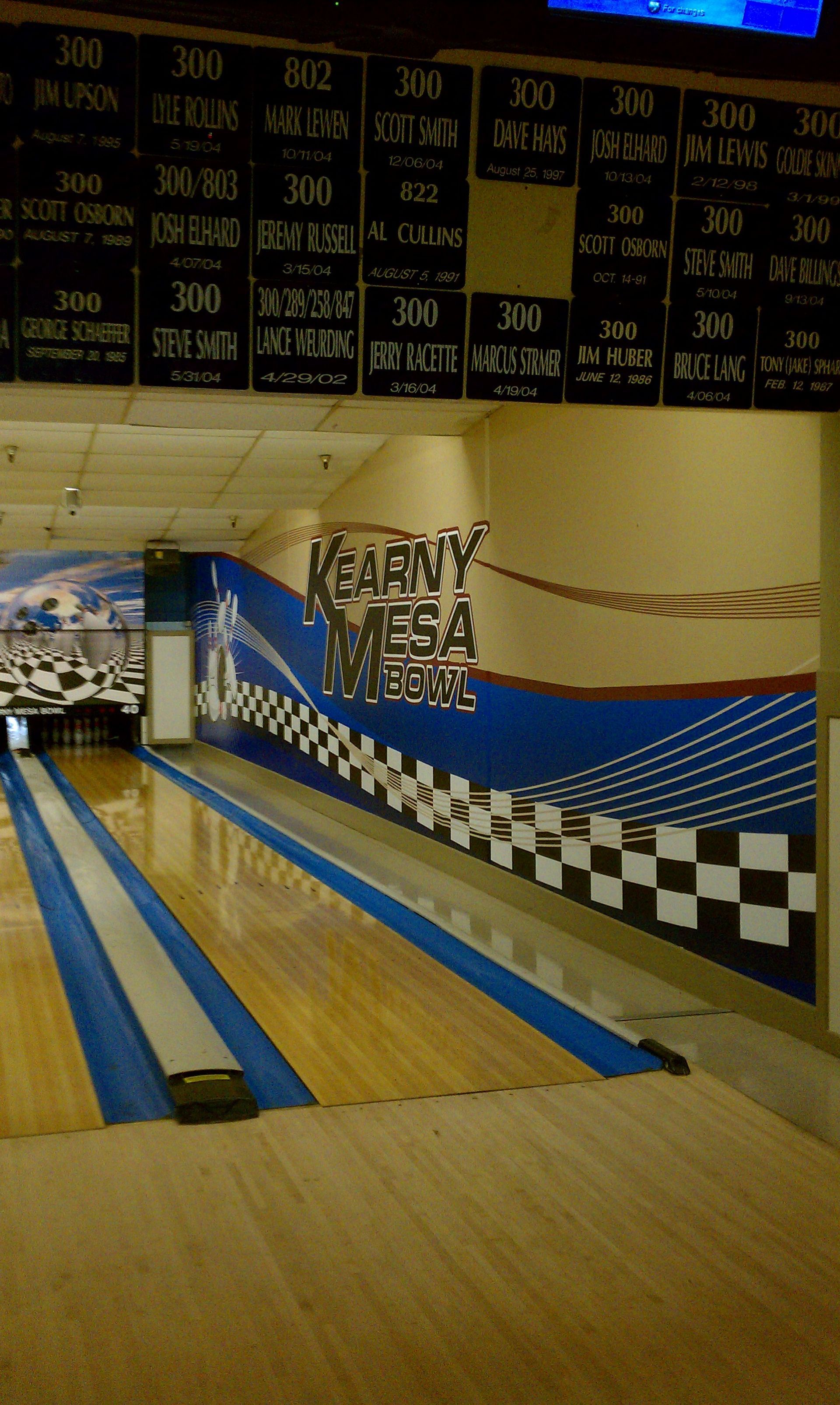 A bowling alley with a blue and white checkered wall