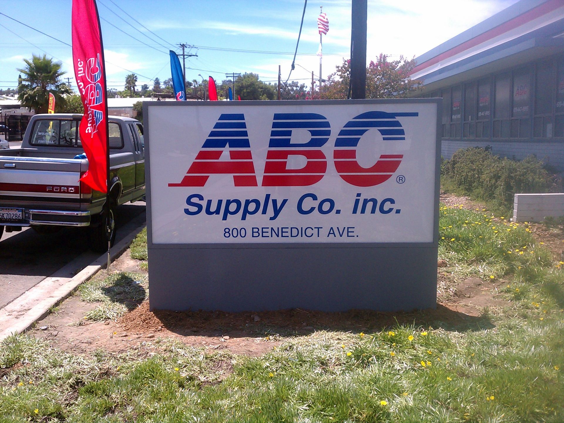 A sign for abc supply co. inc. sits in the grass