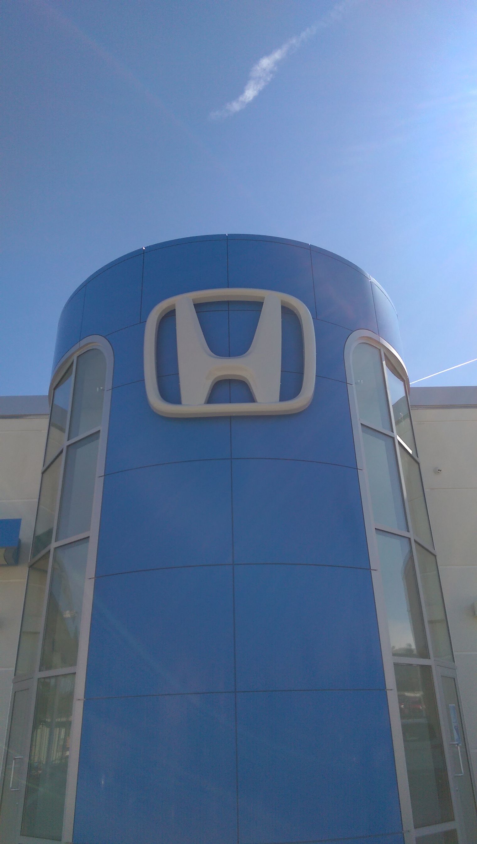 The honda logo is on the side of a building.