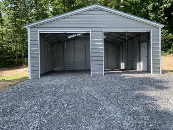 A grey gravel pad installation for a metal garage in Tuscaloosa, Alabama