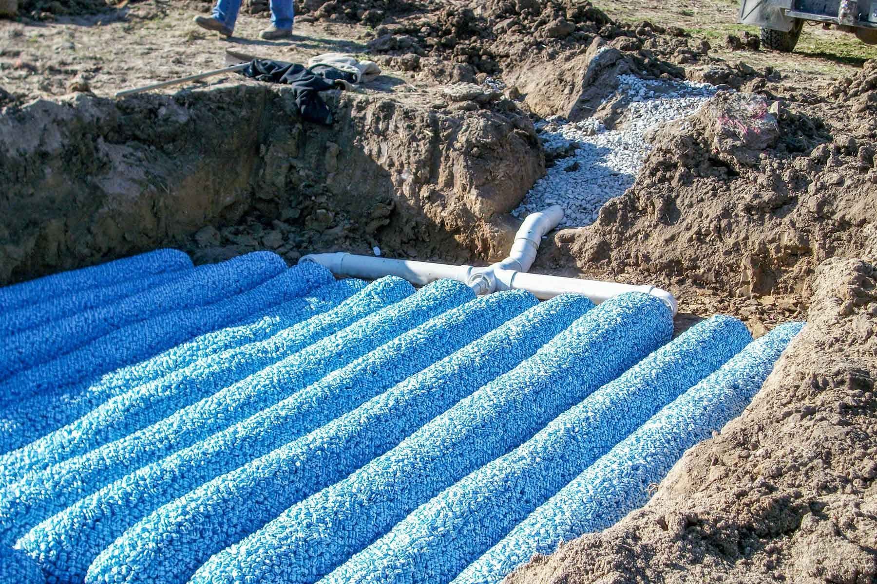 Drainfield repair with blue popcorn lines in Tuscaloosa, Alabama.