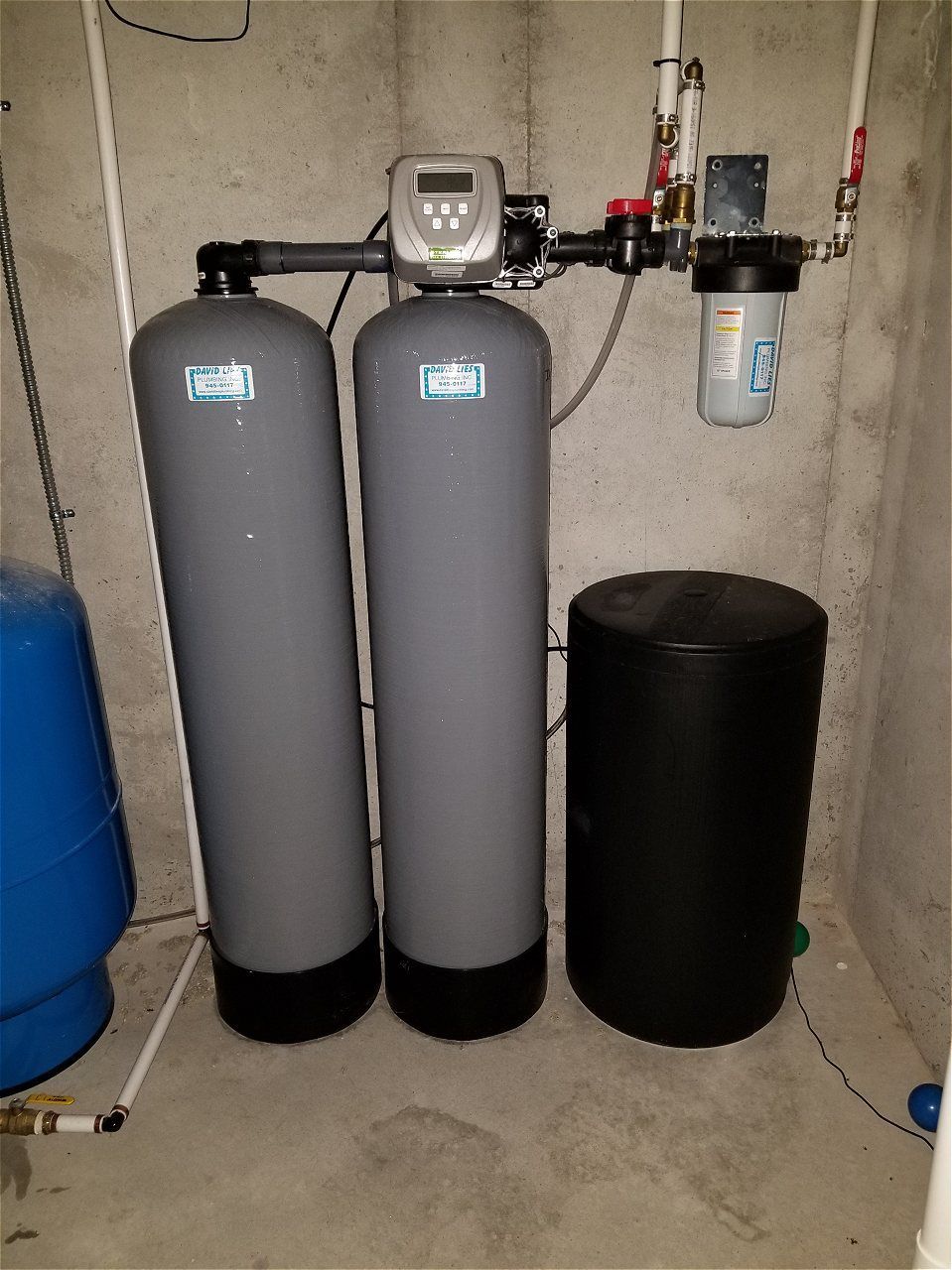 Two Water Filters Are Sitting Next To Each Other In A Basement | Wichita, KS | David Lies Plumbing