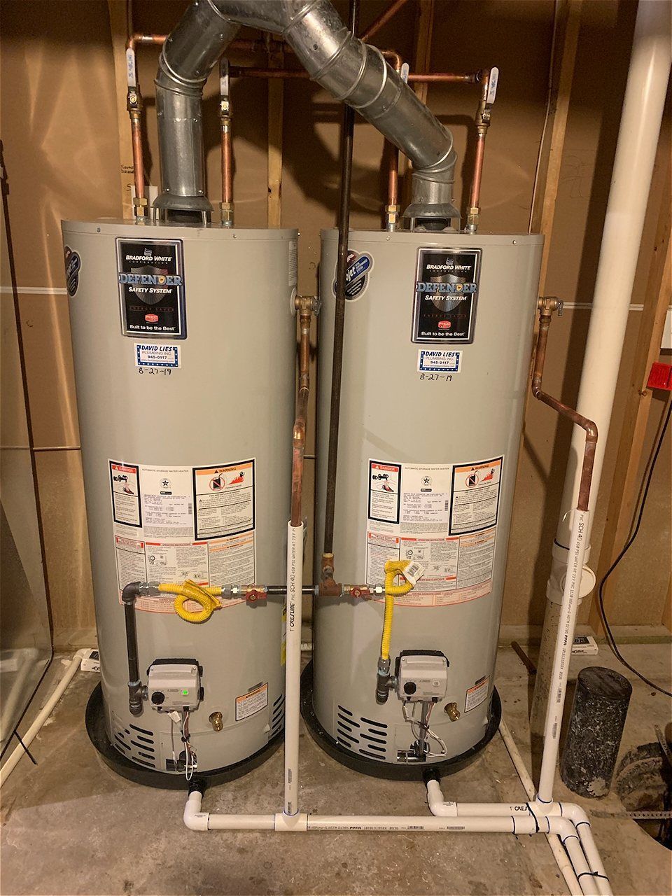 Two Water Heaters Are Sitting Next To Each Other In A Basement | Wichita, KS | David Lies Plumbing