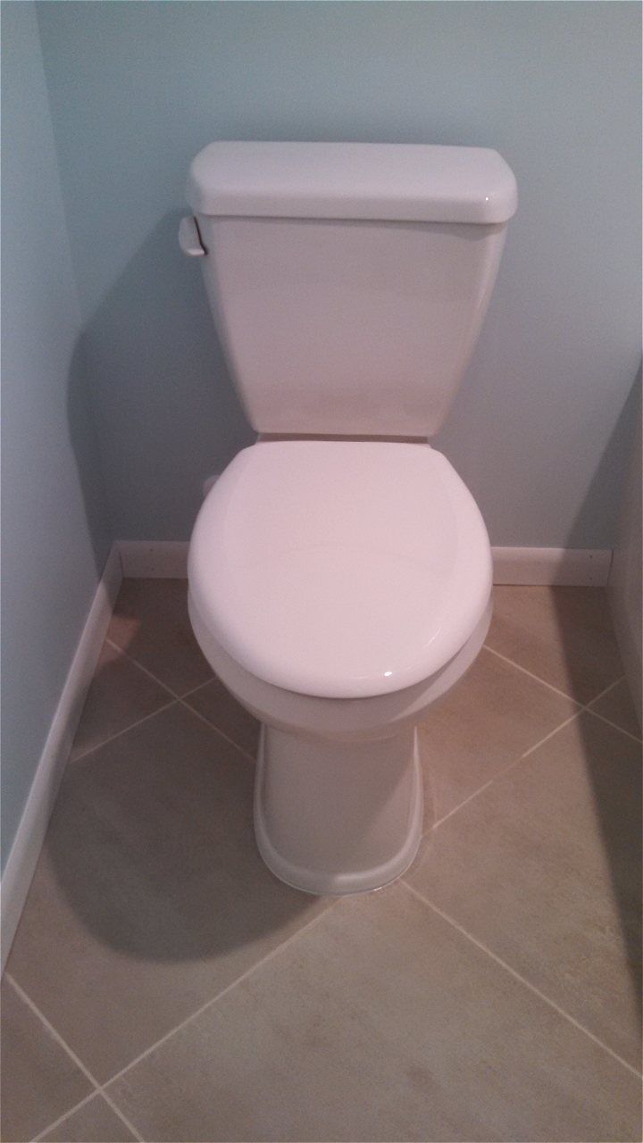 A White Toilet Is Sitting On A Tiled Floor In A Bathroom | Wichita, KS | David Lies Plumbing
