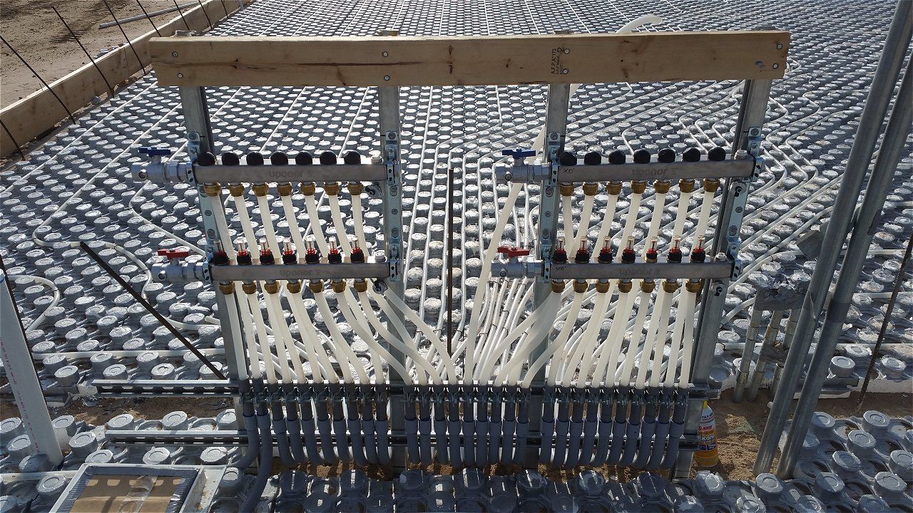 A Metal Fence With A Wooden Railing Is Sitting On Top Of A Concrete Surface | Wichita, KS | David Lies Plumbing