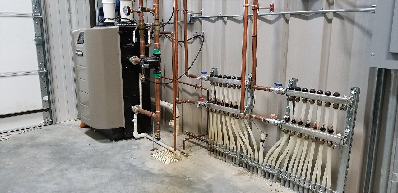 A Room With A Lot Of Pipes And A Boiler On The Wall | Wichita, KS | David Lies Plumbing