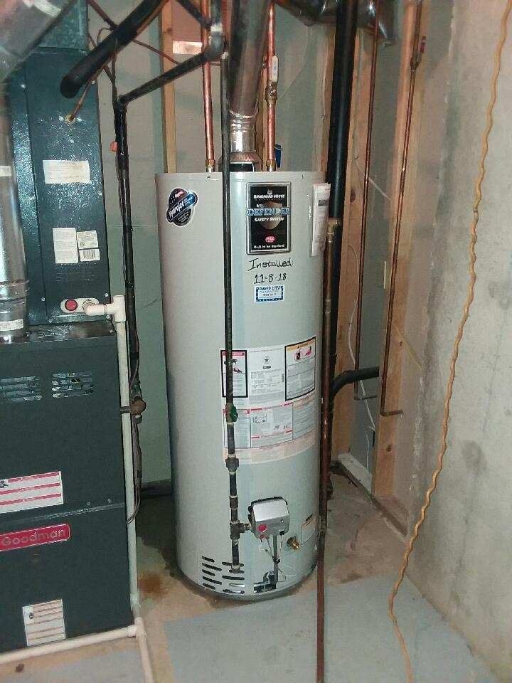 A Water Heater Is Sitting In A Basement Next To An Air Conditioner | Wichita, KS | David Lies Plumbing