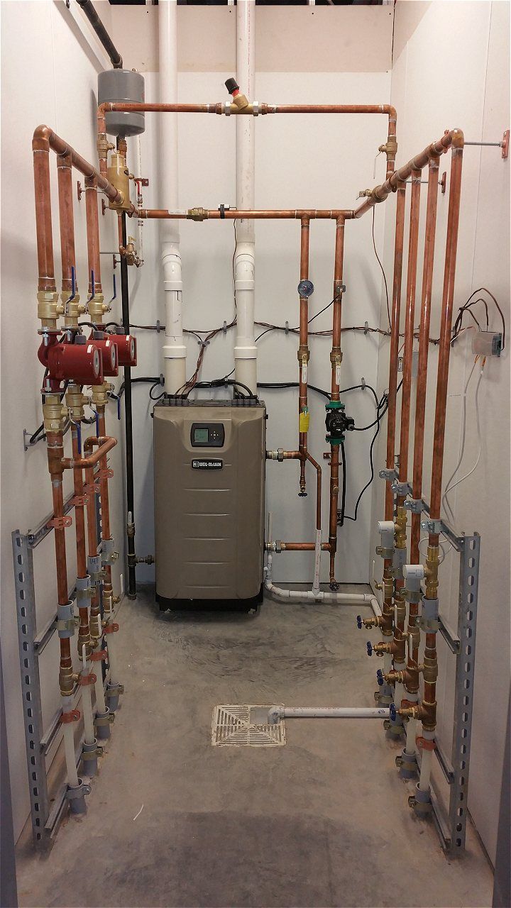 A Room With A Boiler And Pipes In It | Wichita, KS | David Lies Plumbing