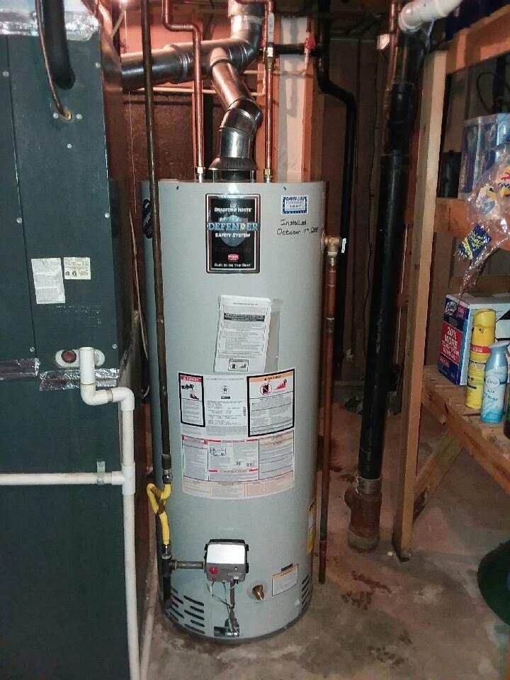 A Water Heater Is Sitting In A Basement Next To A Furnace | Wichita, KS | David Lies Plumbing
