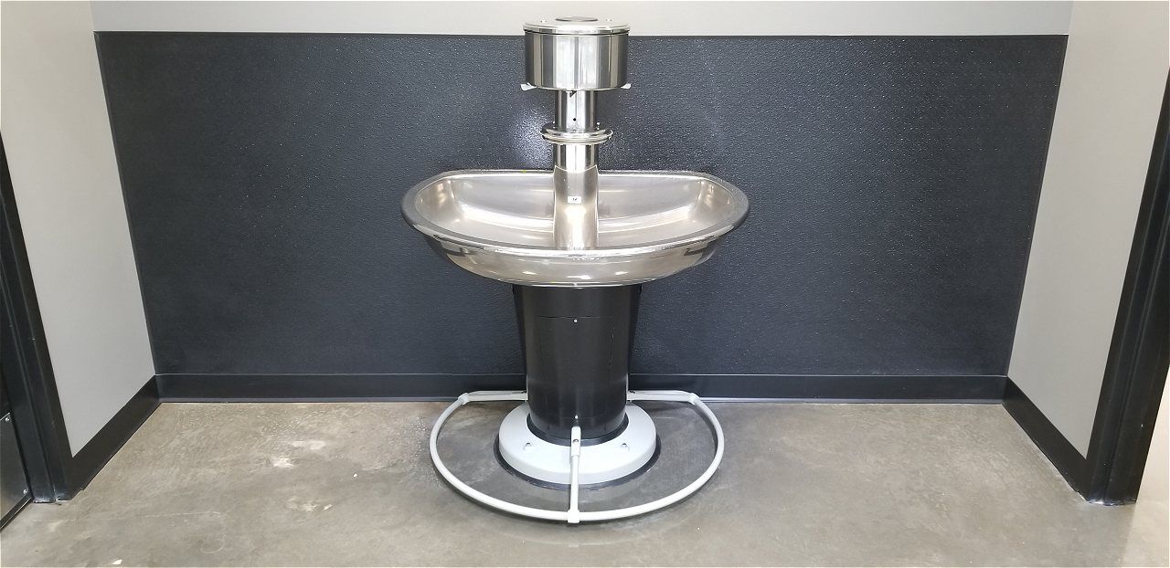 A Stainless Steel Sink Is Sitting In A Bathroom Next To A Black Wall | Wichita, KS | David Lies Plumbing