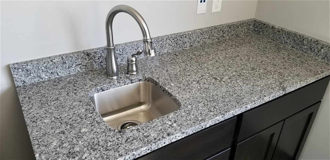 A Kitchen Sink With A Faucet On A Granite Counter Top | Wichita, KS | David Lies Plumbing