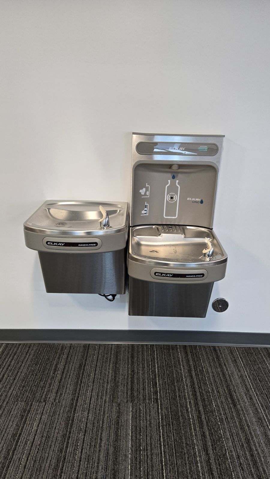 A wall-mounted water fountain with a drinking fountain and water bottle filler.