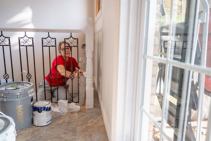 An empty room with a wooden floor and a ladder. An empty room with a wooden floor and a ladder.