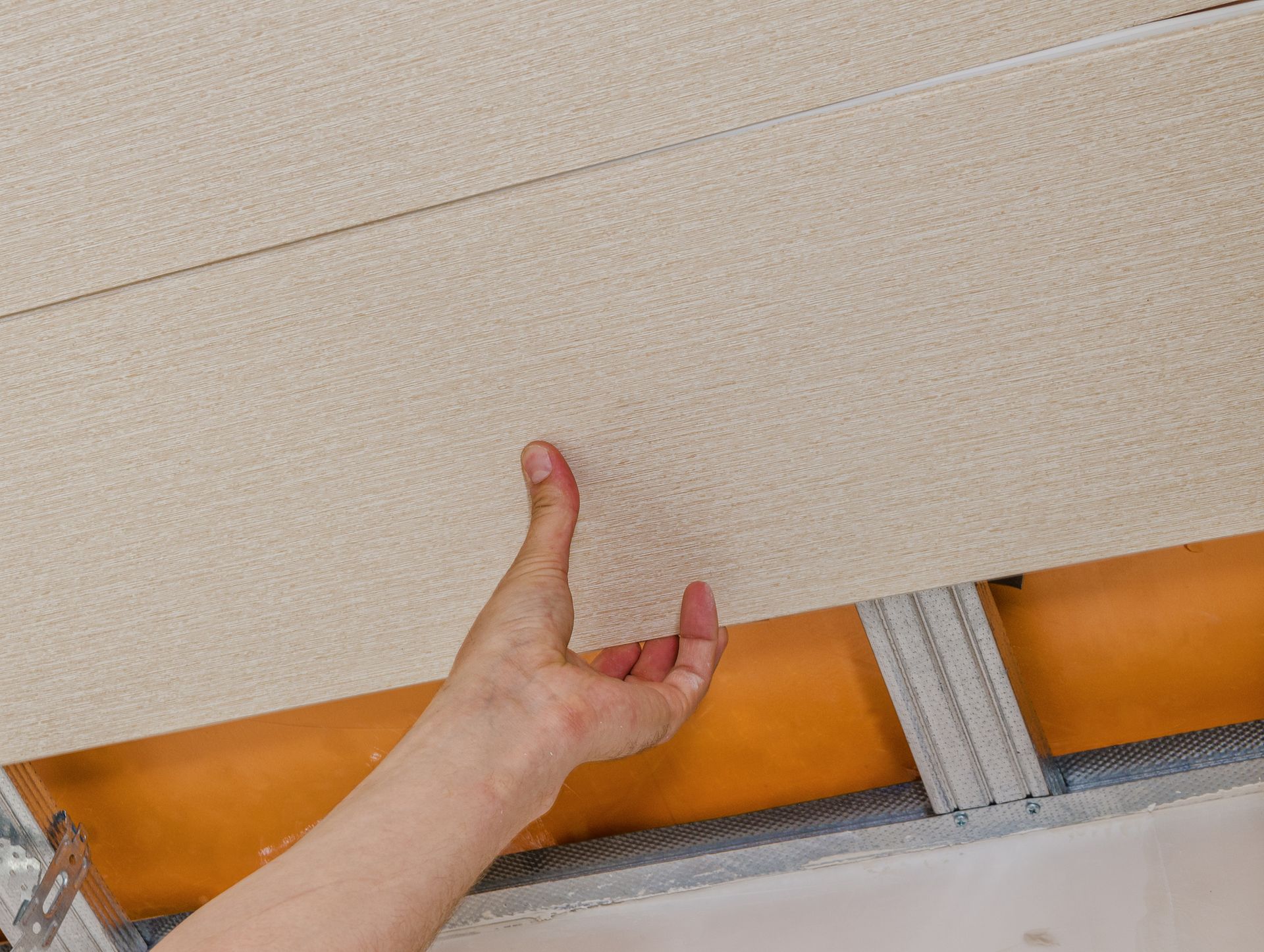 A person is holding a piece of wood in their hand.