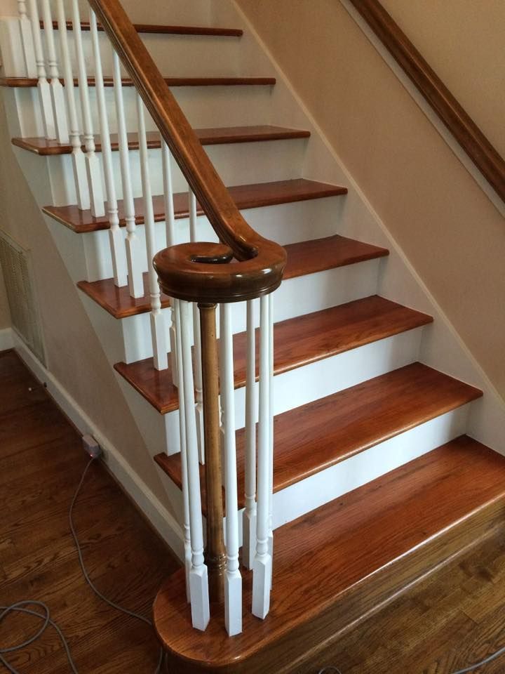 A staircase with wooden steps and white railings
