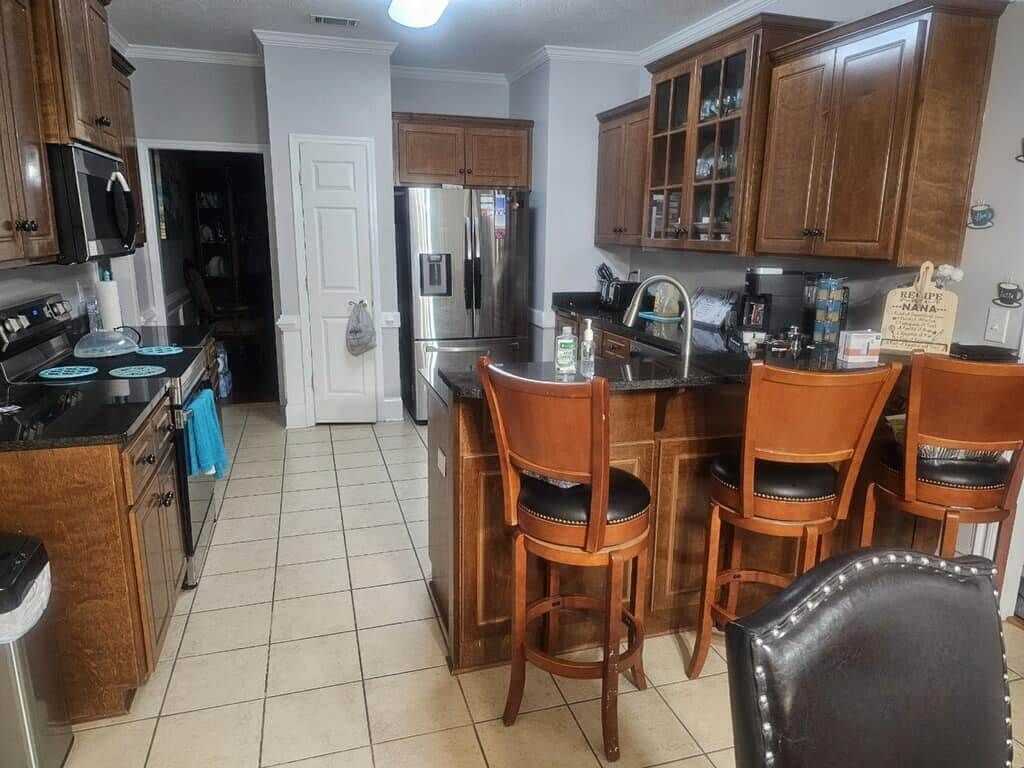 A kitchen with stainless steel appliances and wooden cabinets