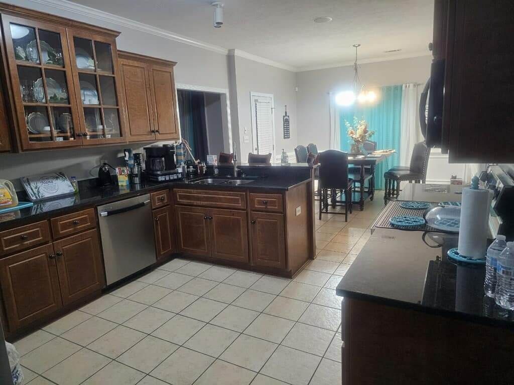 A kitchen with stainless steel appliances and wooden cabinets