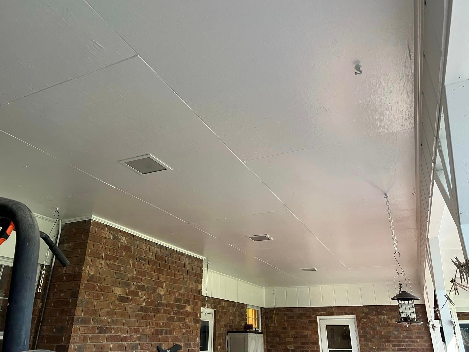 A room with a brick wall and a white ceiling