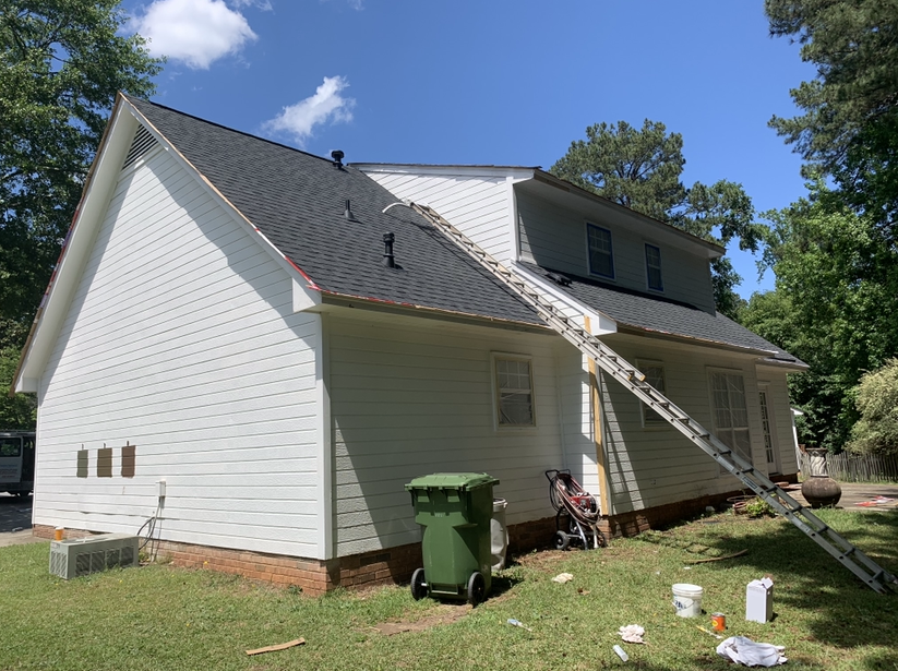 A statue of a man wearing sunglasses on a pink background