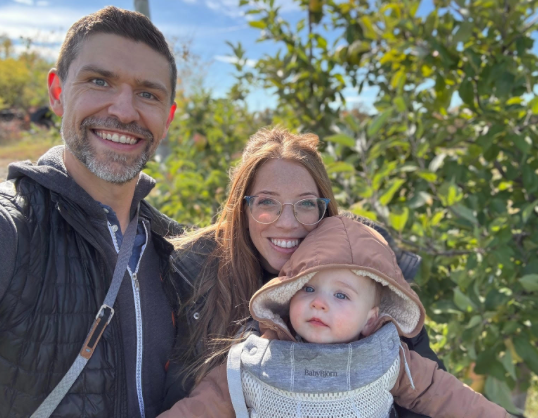 A group of people dressed as santa claus and mrs. claus are posing for a picture on a plane.