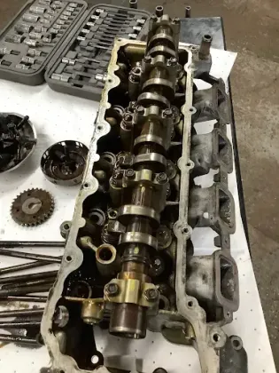 A close up of a cylinder head on a table.