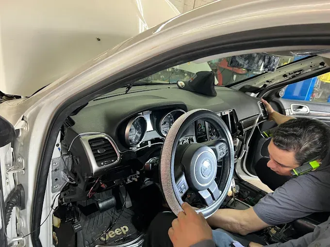 Technician inspecting a used car
