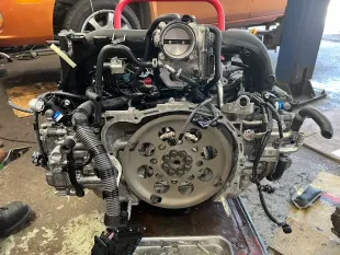 A subaru engine is being worked on in a garage.