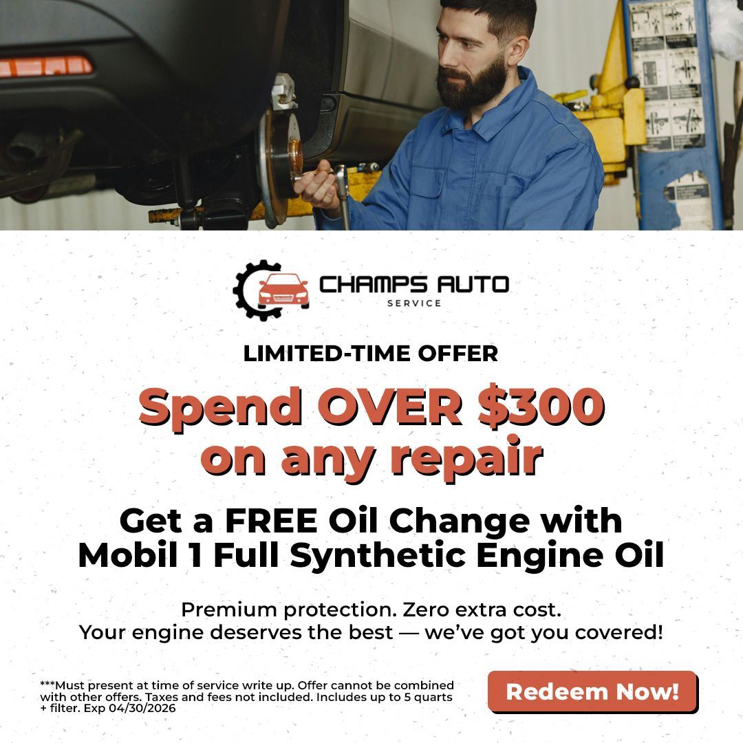 A mechanic works on a car in a shop for a Champs Auto Service promotional offer for a free oil change on repairs over $300.