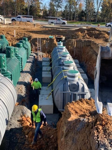 A group of construction workers are working on a septic system