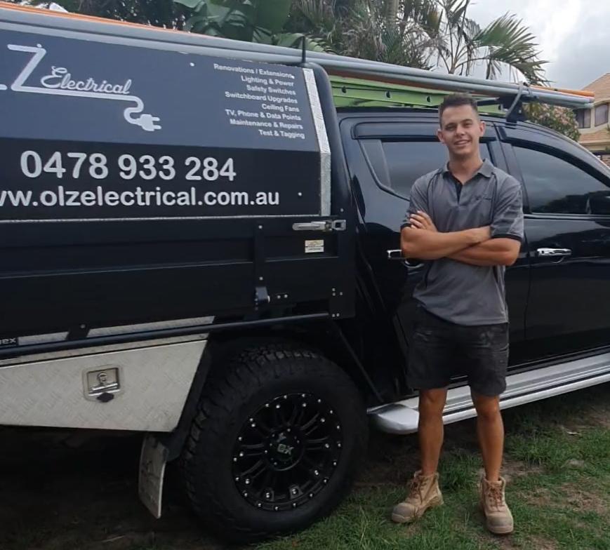 Man Standing Beside Vehicle — Electrical Services in Southport, QLD