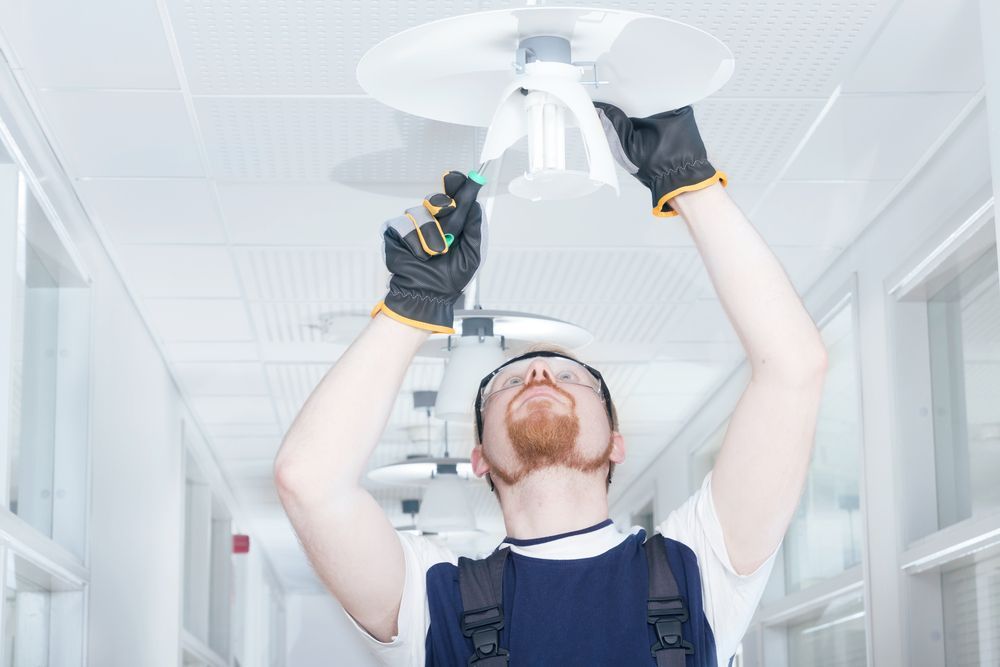 Electrician Repairing Broken Light — Electrical Services in Nerang, QLD