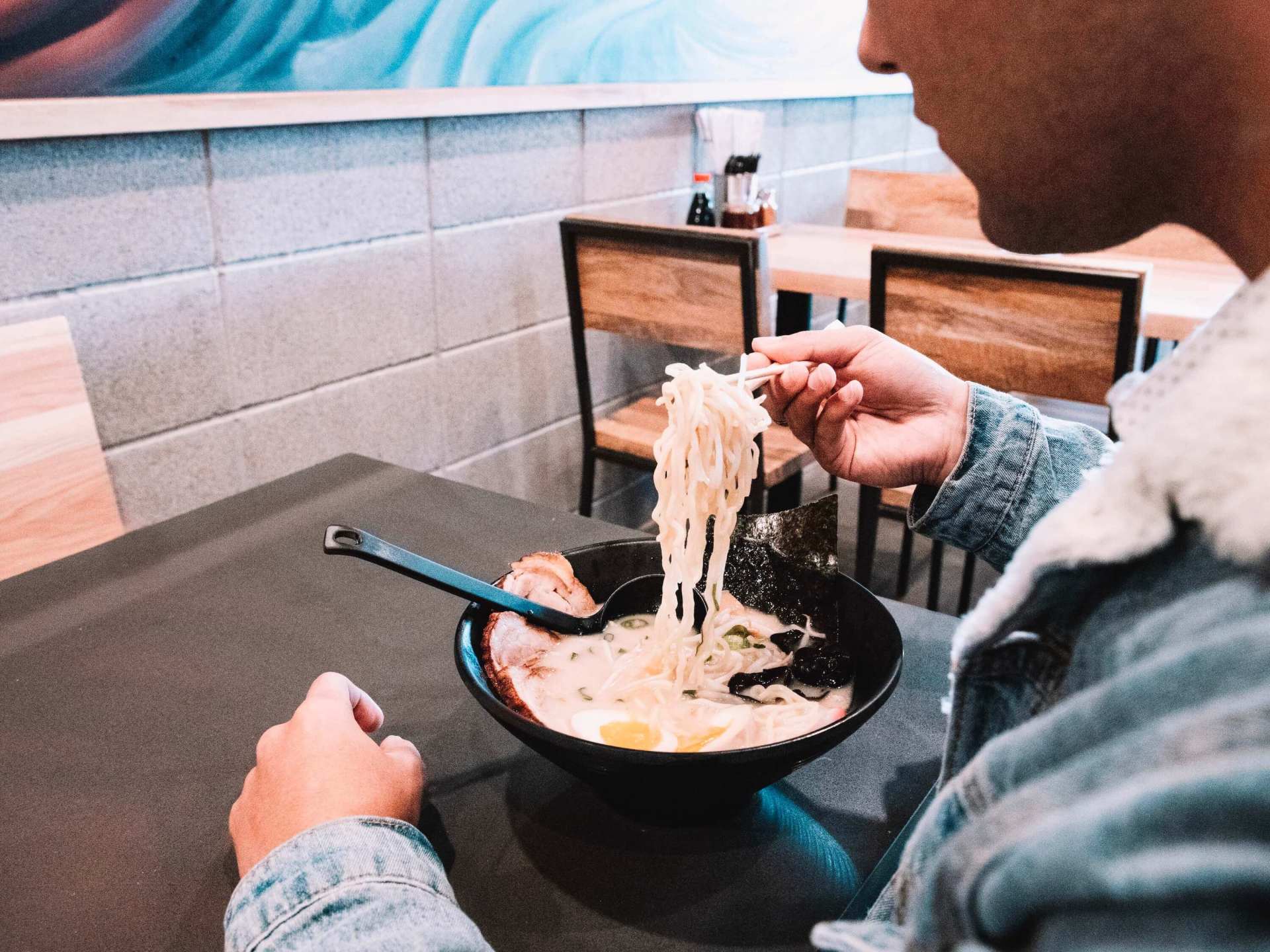 man eating ramen at koshi ramen bar