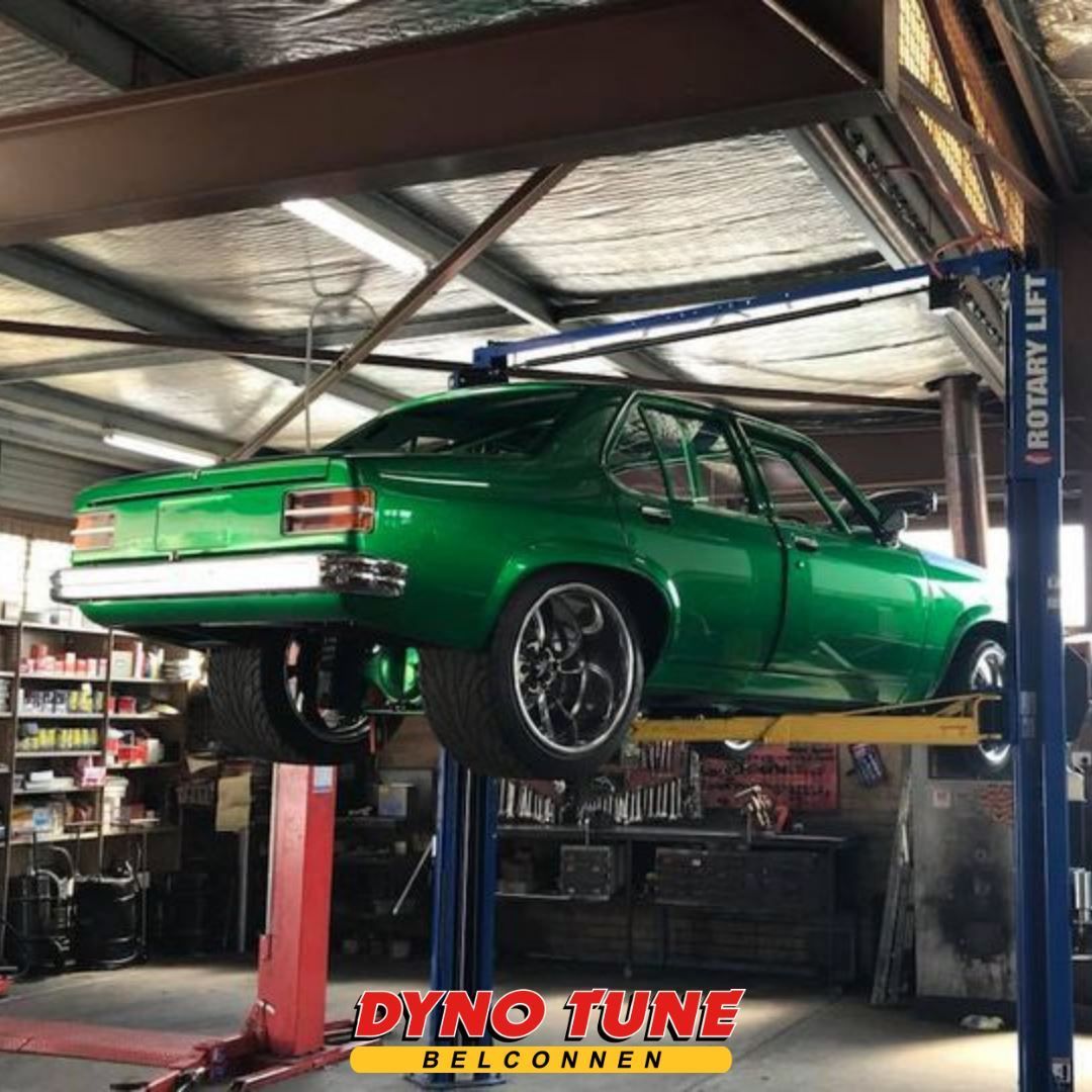 Green Car On Car Lift — Mechanic In Belconnen, ACT