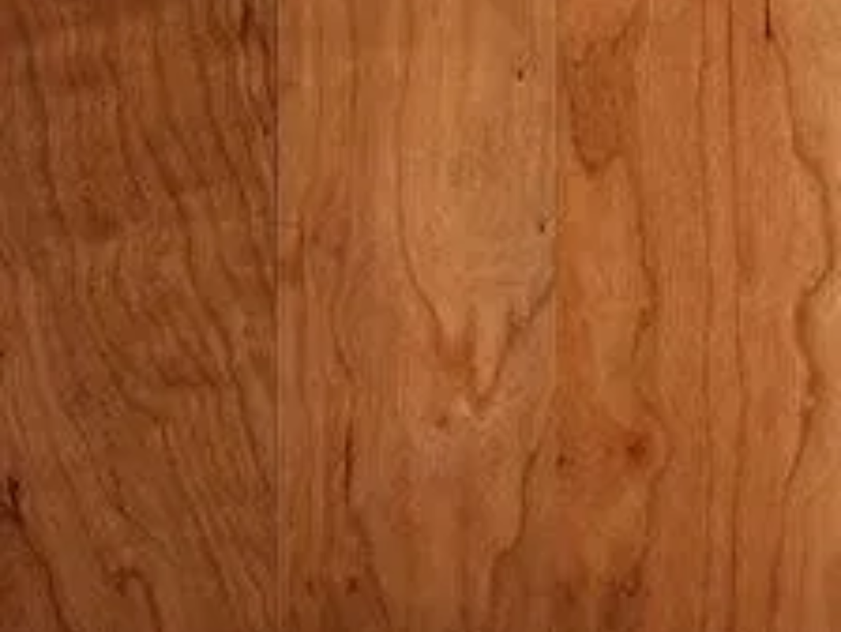 Close-up of light brown hardwood flooring with visible wood grain and knots.