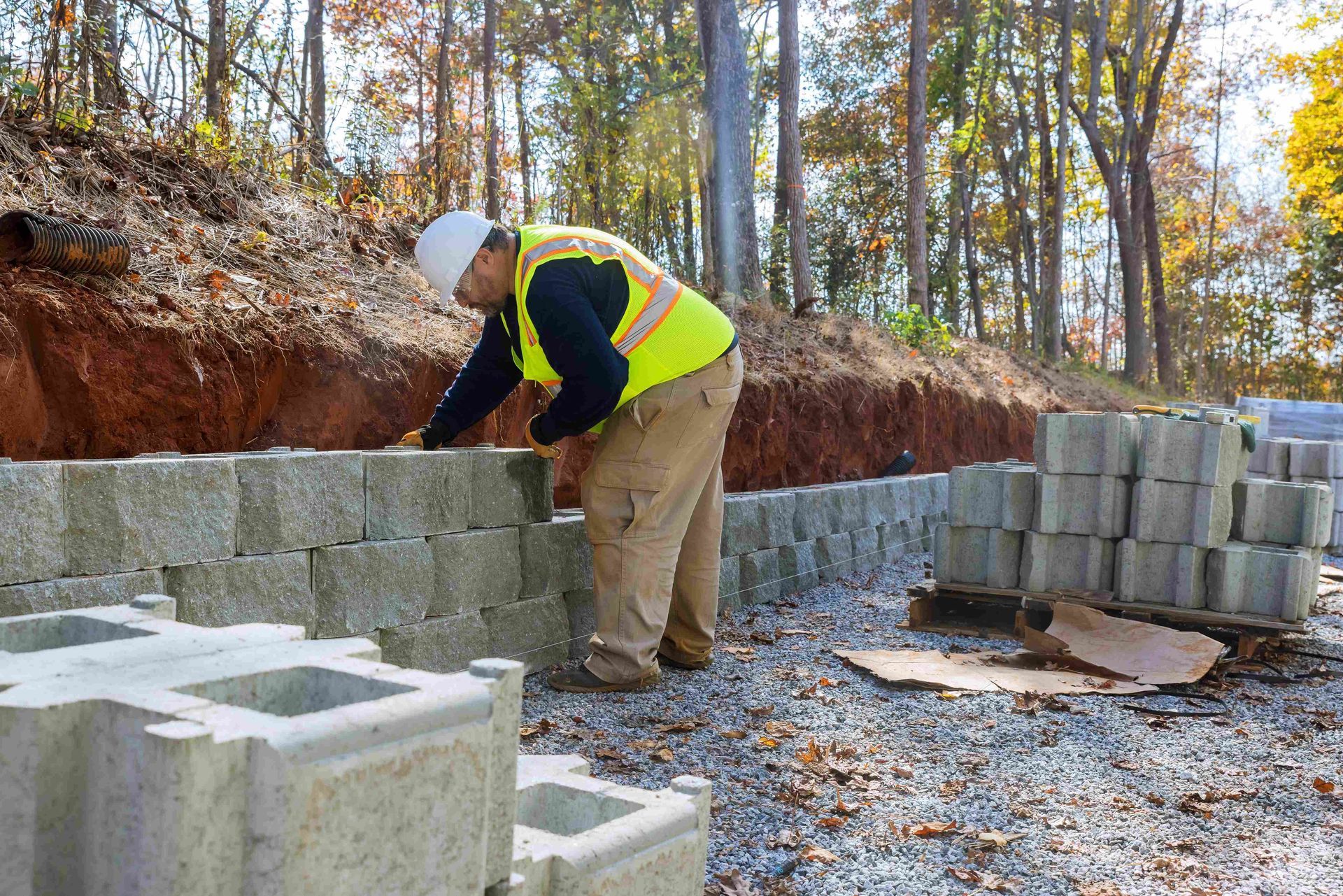 a mason worker is working on a concrete wall