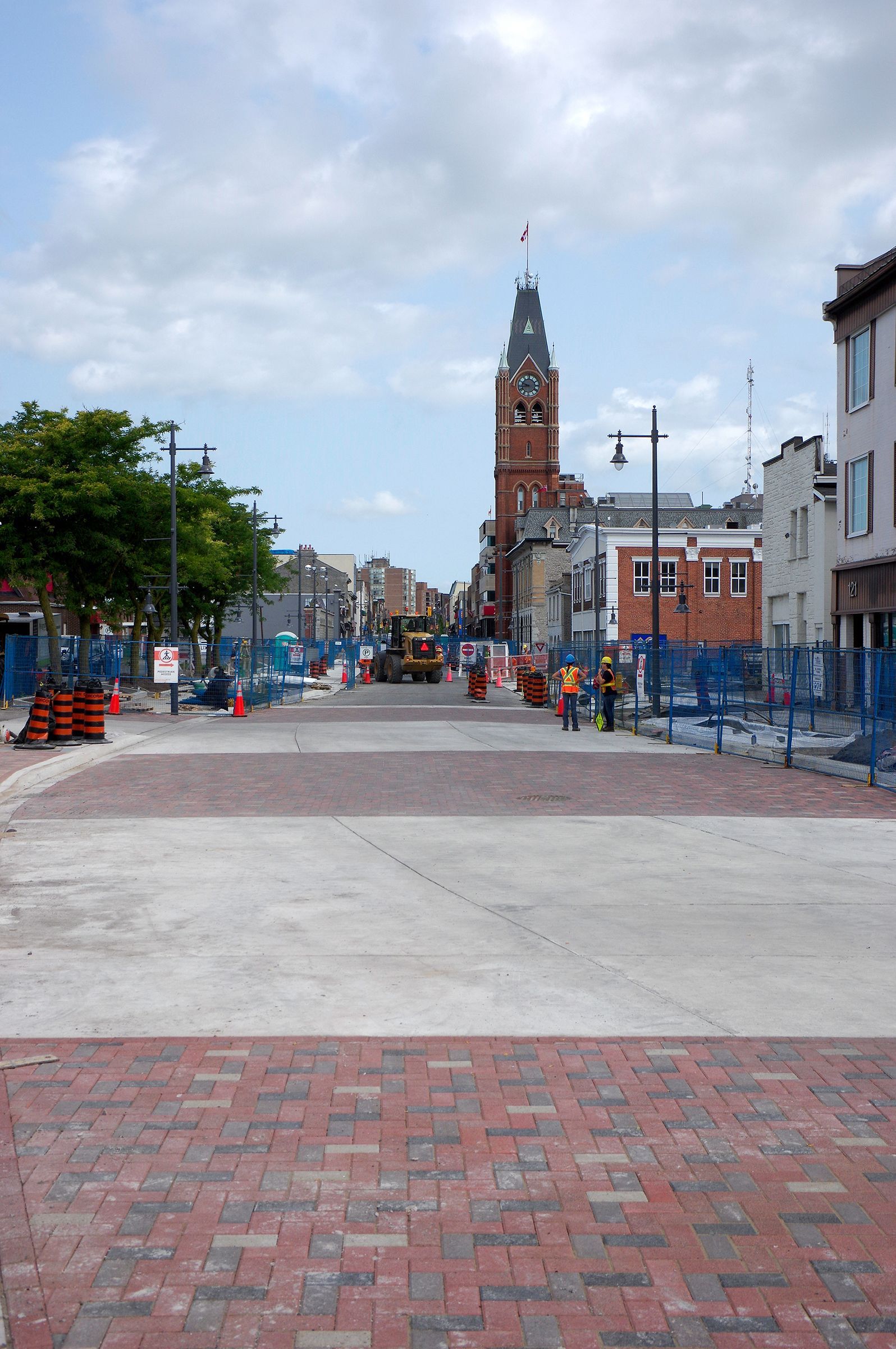 A city street with a clock tower in the background