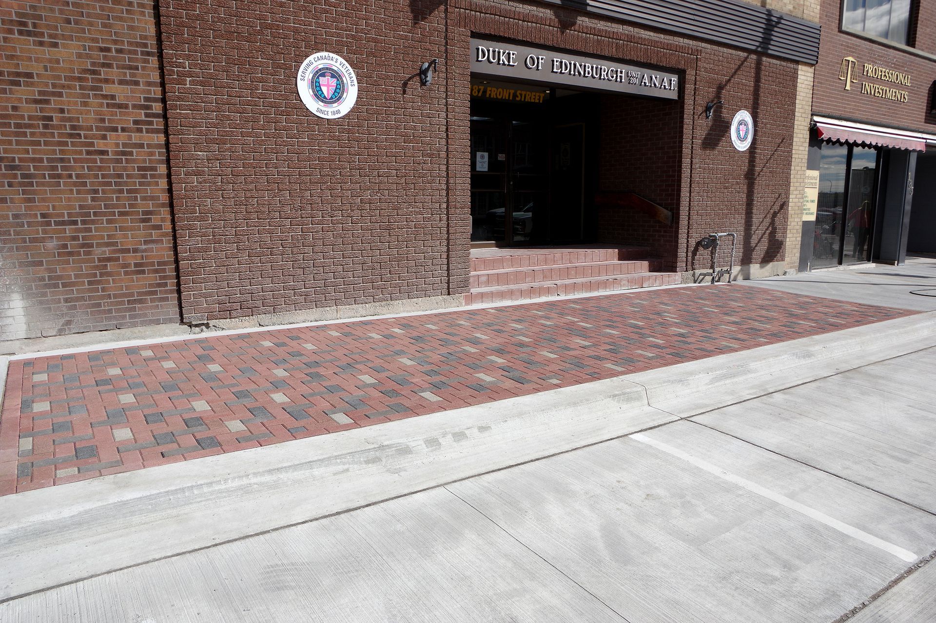 A brick building with stairs leading up to it
