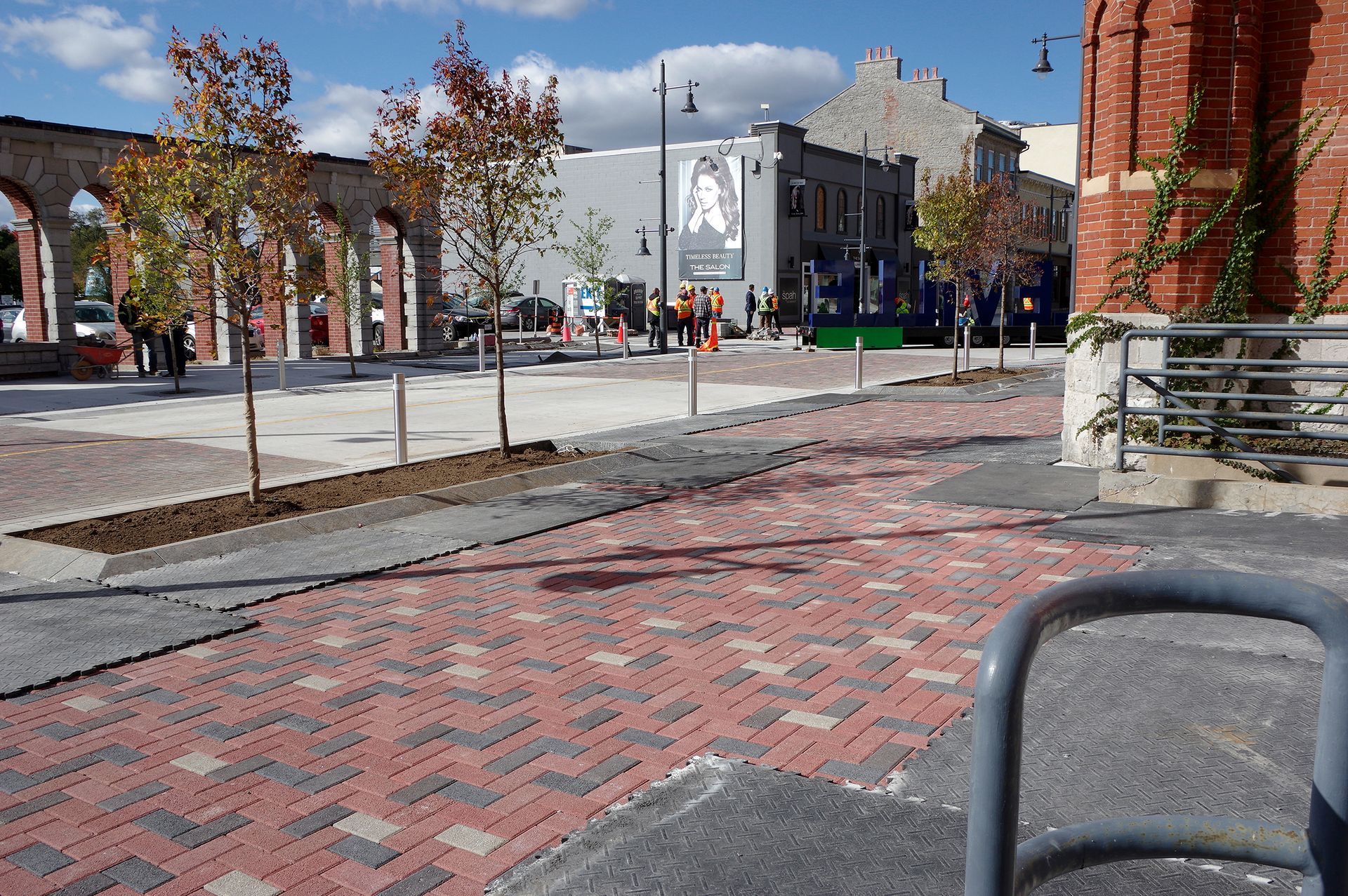 A brick walkway with a sign that says ' a ' on it