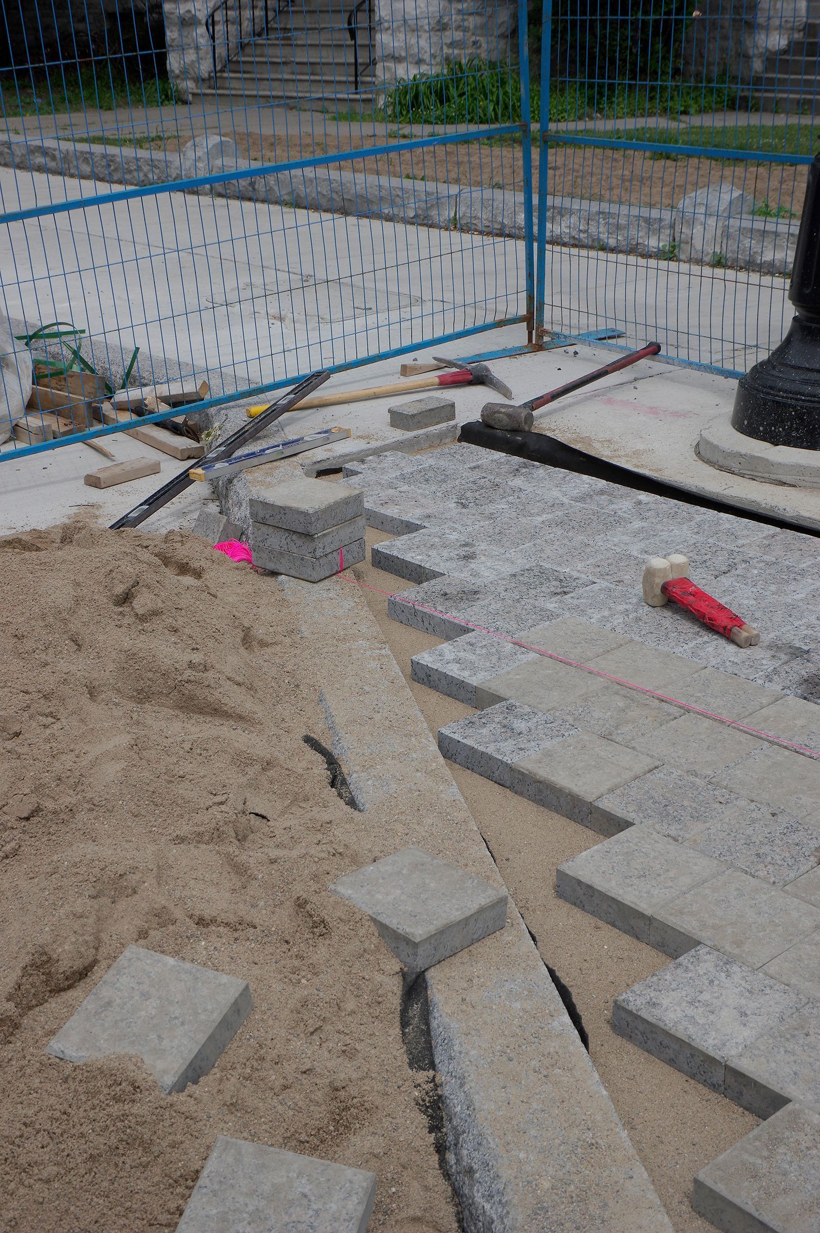 A bunch of bricks are sitting on top of a pile of sand.