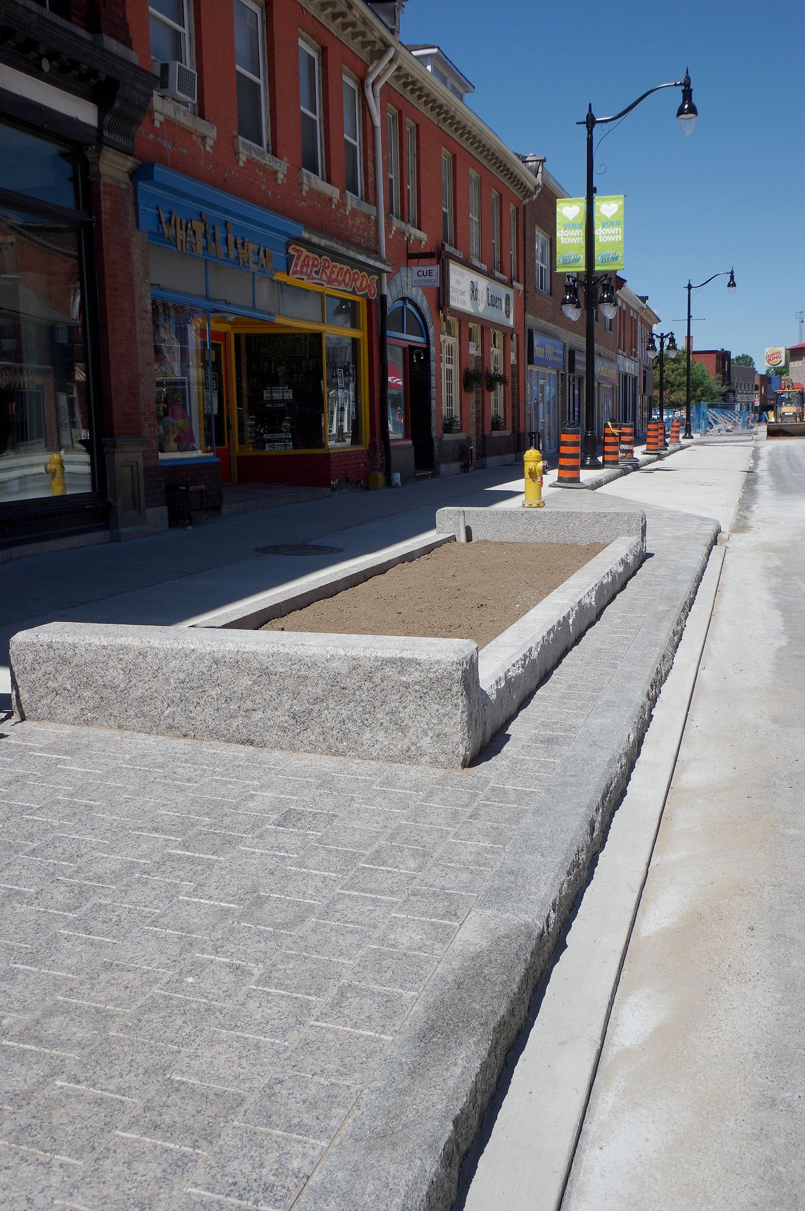 A fire hydrant is in the middle of a sidewalk in front of a building that says ' abercrombie & fitch '
