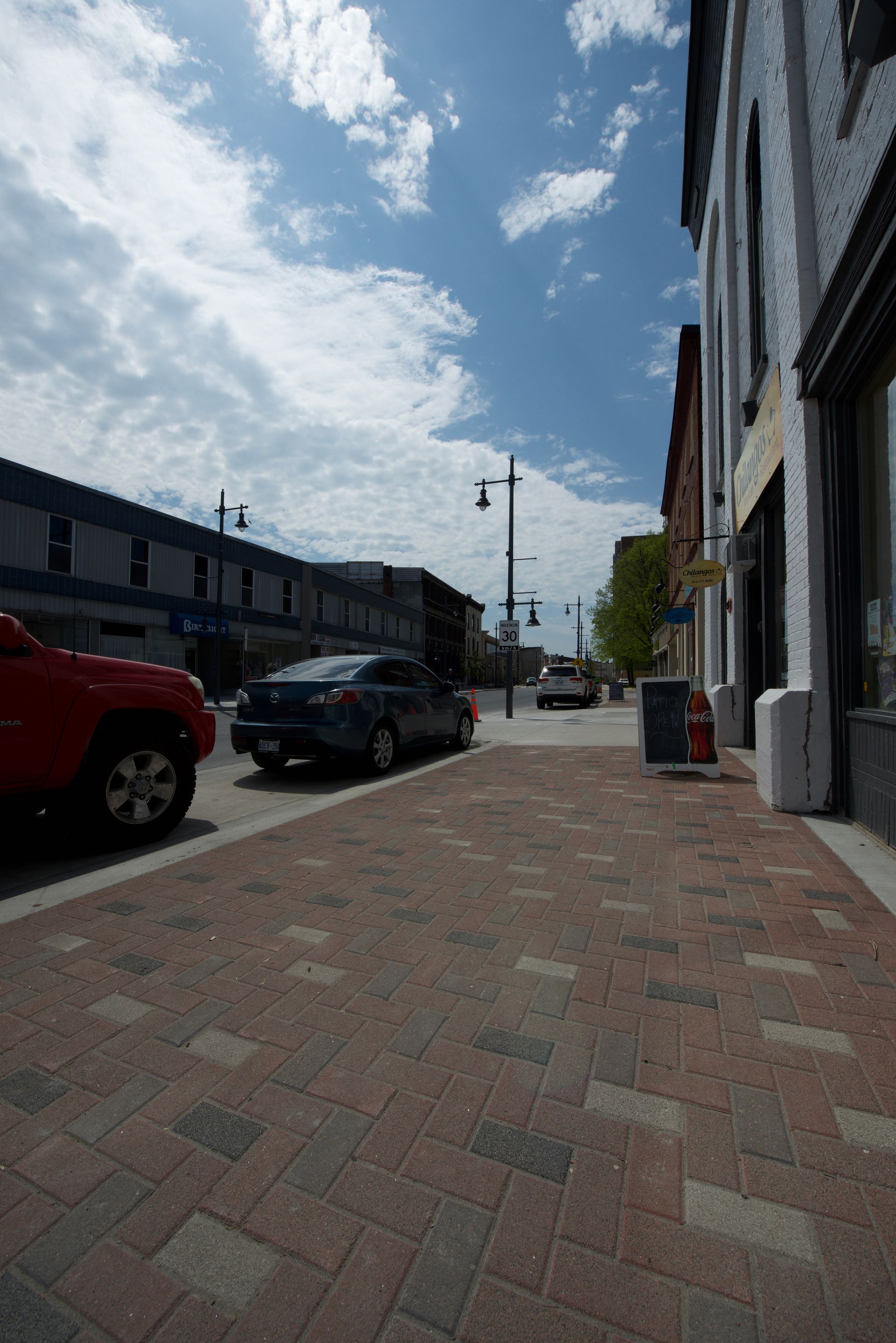 A red truck is parked on the side of the road
