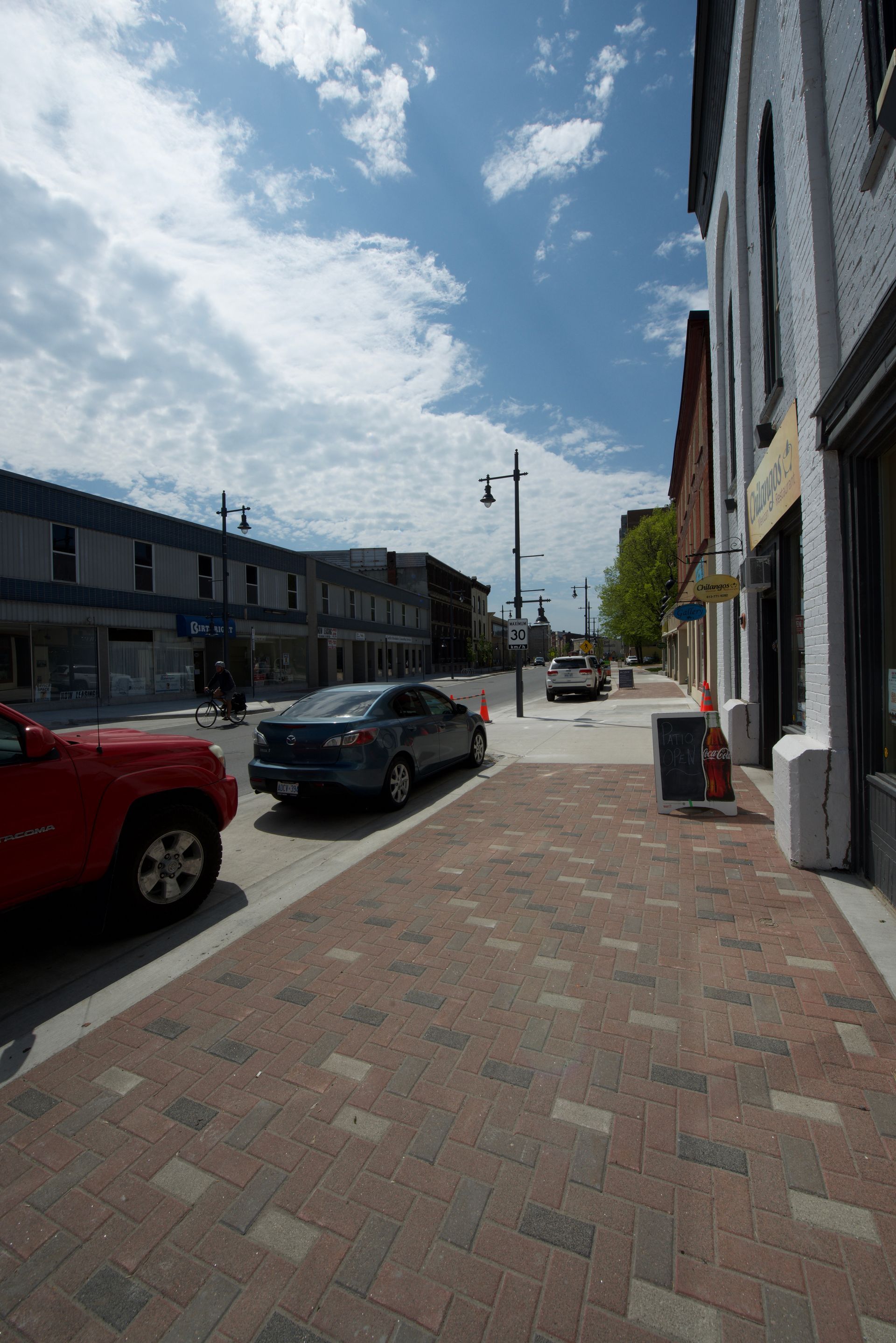 A red truck is parked on the side of the road