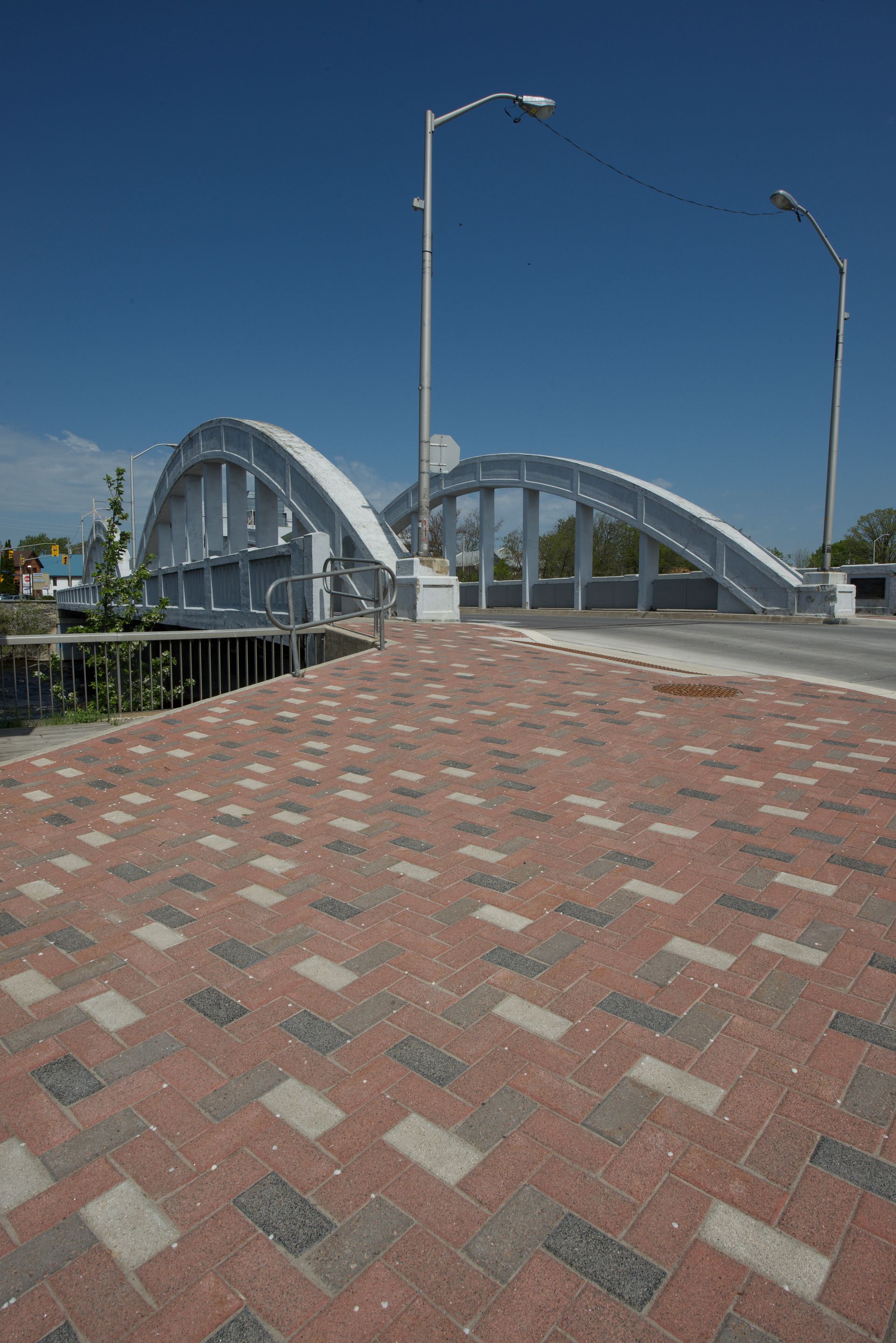 A bridge with a brick walkway leading to it