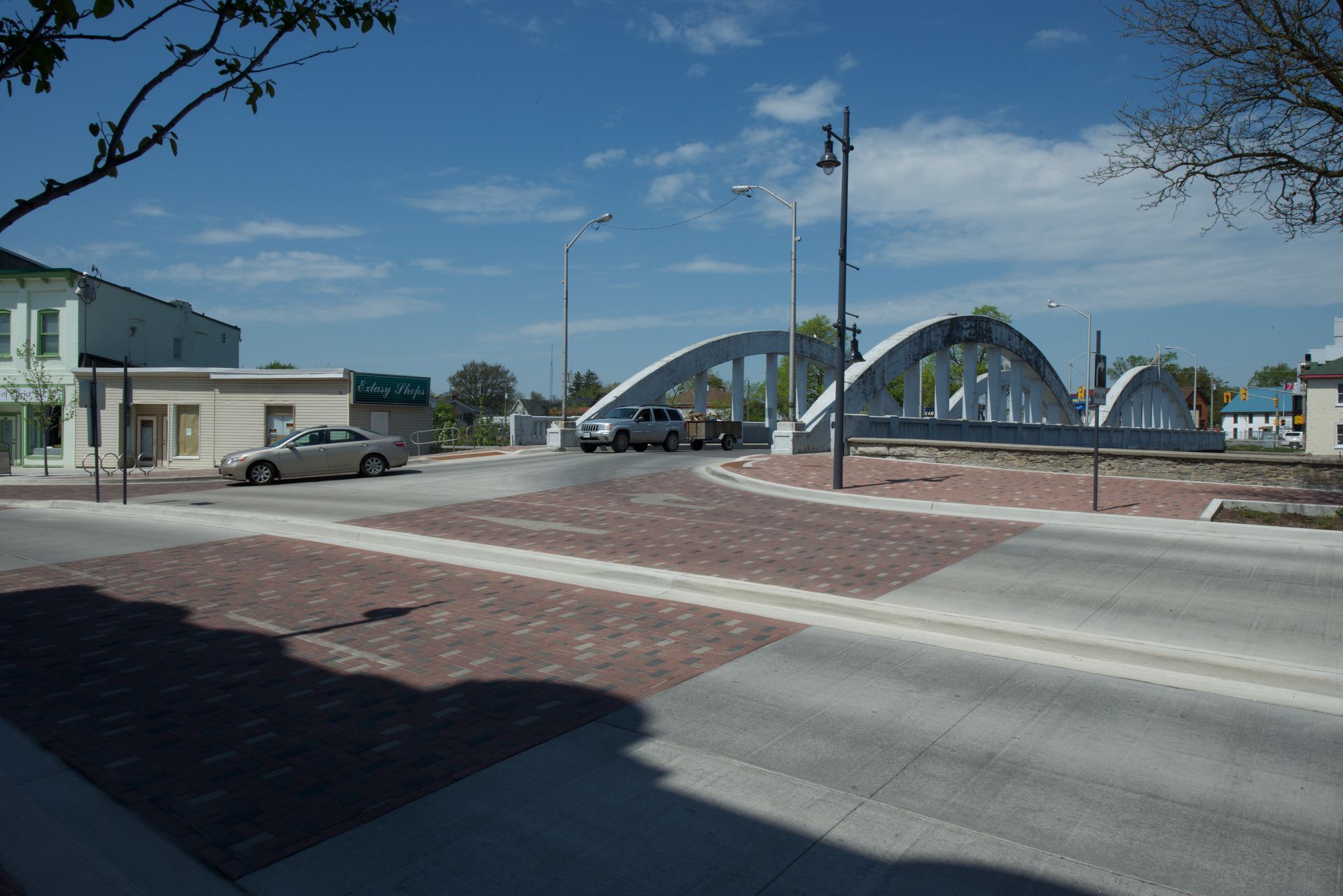 A bridge is visible in the background of a street scene