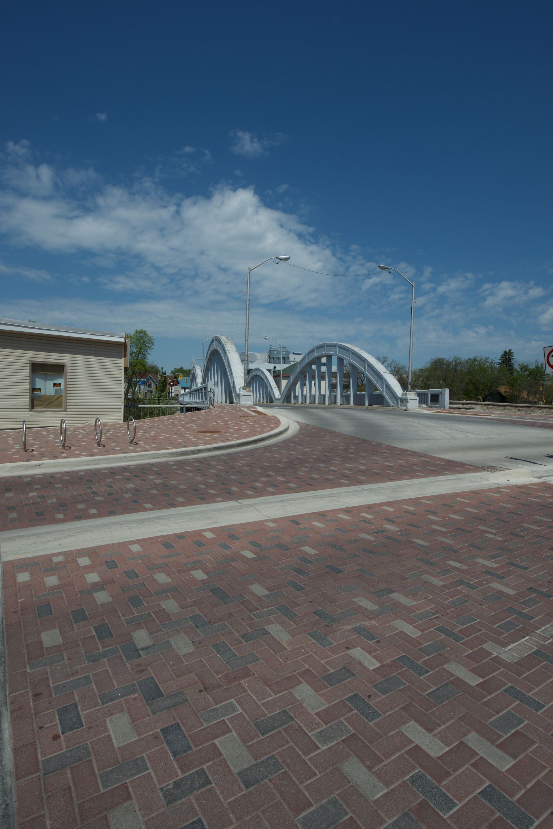 There is a bridge in the background and a building in the foreground.