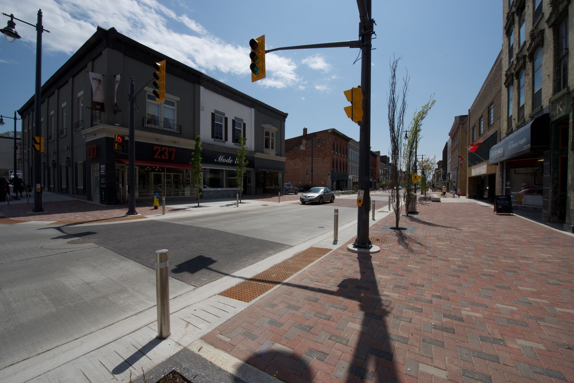 A car is driving down a street in a city