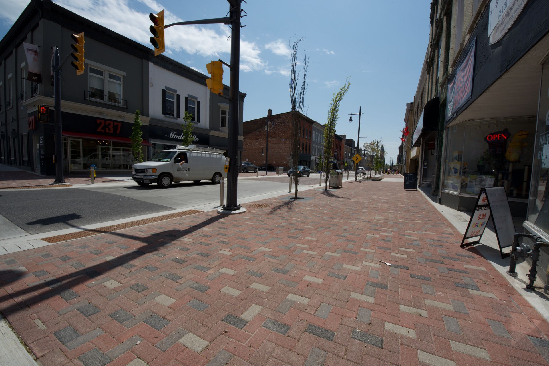 A white van is driving down a city street