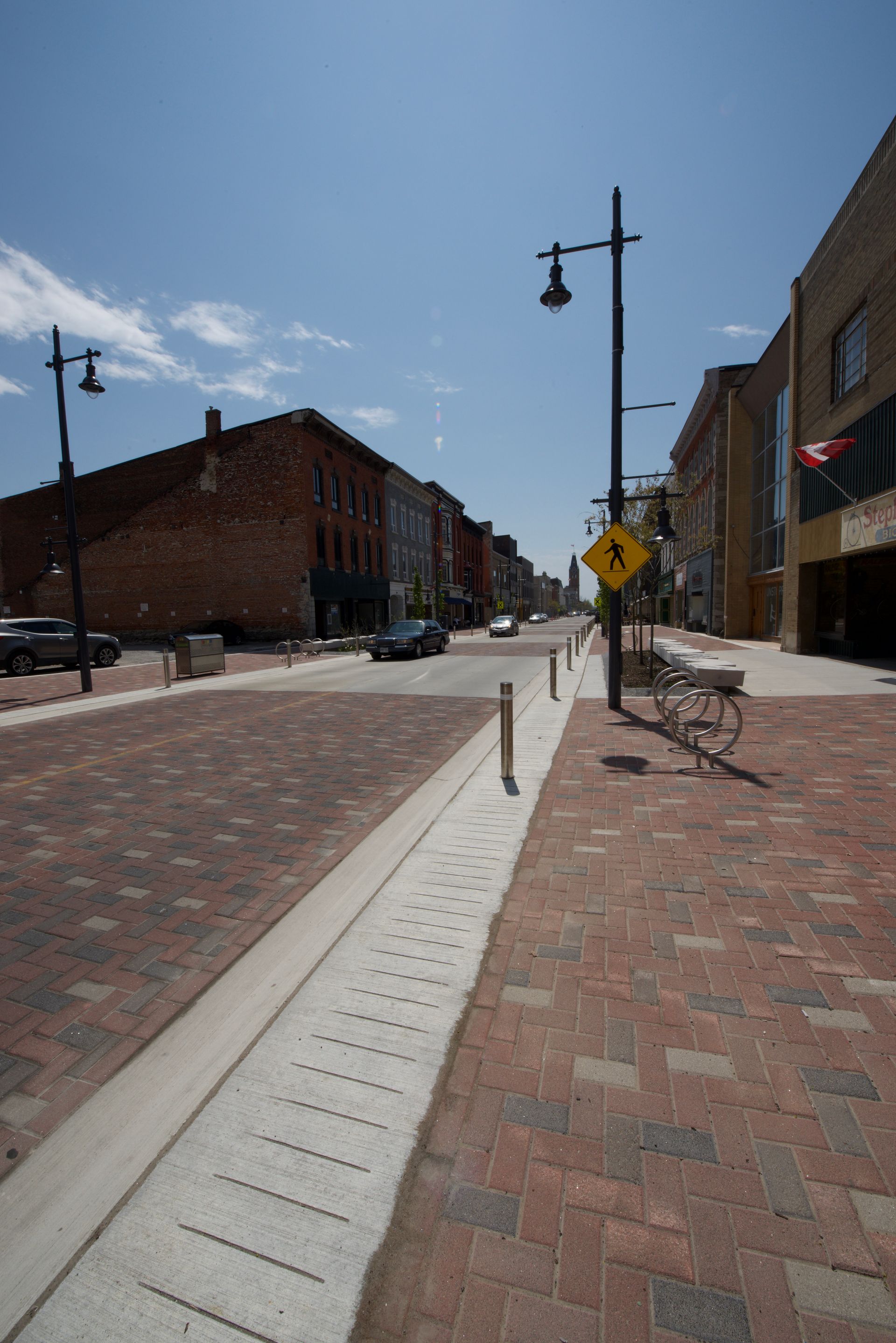 A street with a yellow sign on the side of it