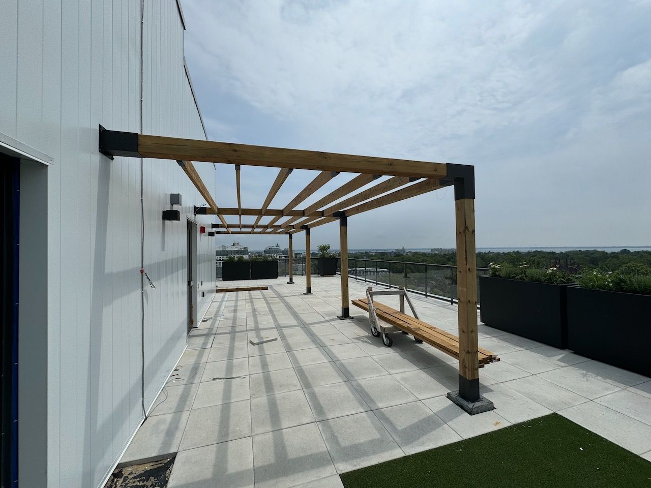 There is a pergola on the roof of a building.